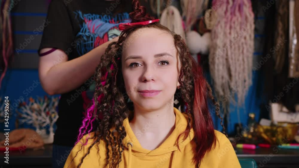Unrecognizable person makes hairstyle for young woman in salon. Professional hairstylist makes hairdo for client. Unrecognizable person makes hairstyle for young woman in salon. Professional hairstylist makes hairdo for client.