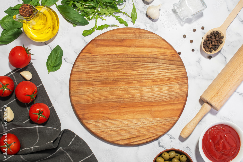 White culinary background with wooden board and pizza ingredients. White culinary background with wooden board and pizza ingredients.