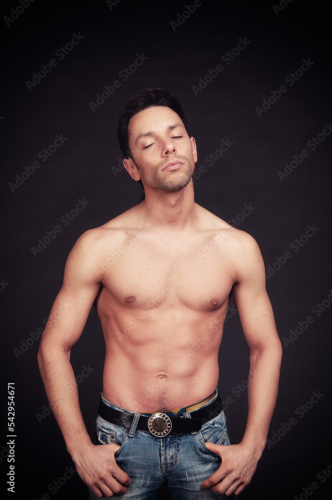Young attractive guy posing in the studio. Beautiful body. Young attractive guy posing in the studio. Beautiful body.