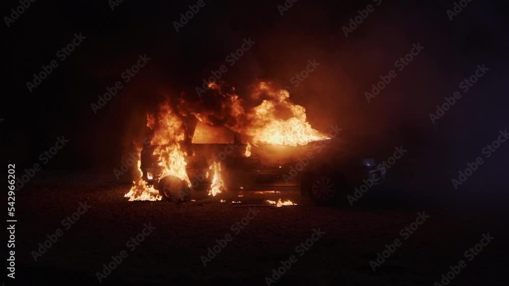 Burning car wide shot. Automobile on fire at night. Transport explosion. Burning car wide shot. Automobile on fire at night. Transport explosion.