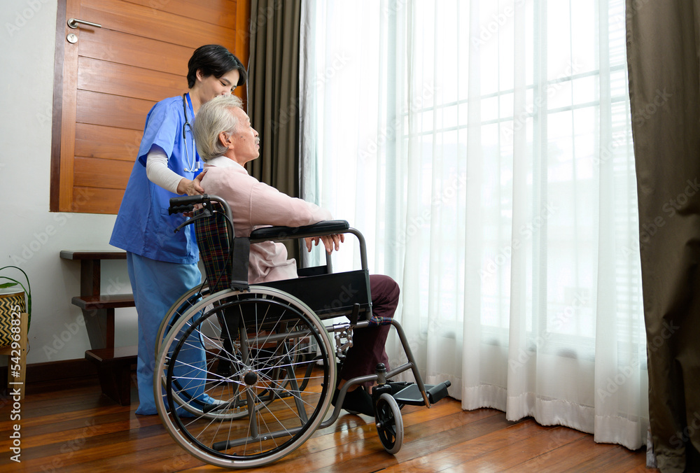 Asian nurse taking care of an elderly man sitting on wheelchair at senior healthcare center. Asian nurse taking care of an elderly man sitting on wheelchair at senior healthcare center.