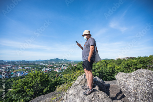 Asian fat man stand on the rock at Khao hin lek fai view point.