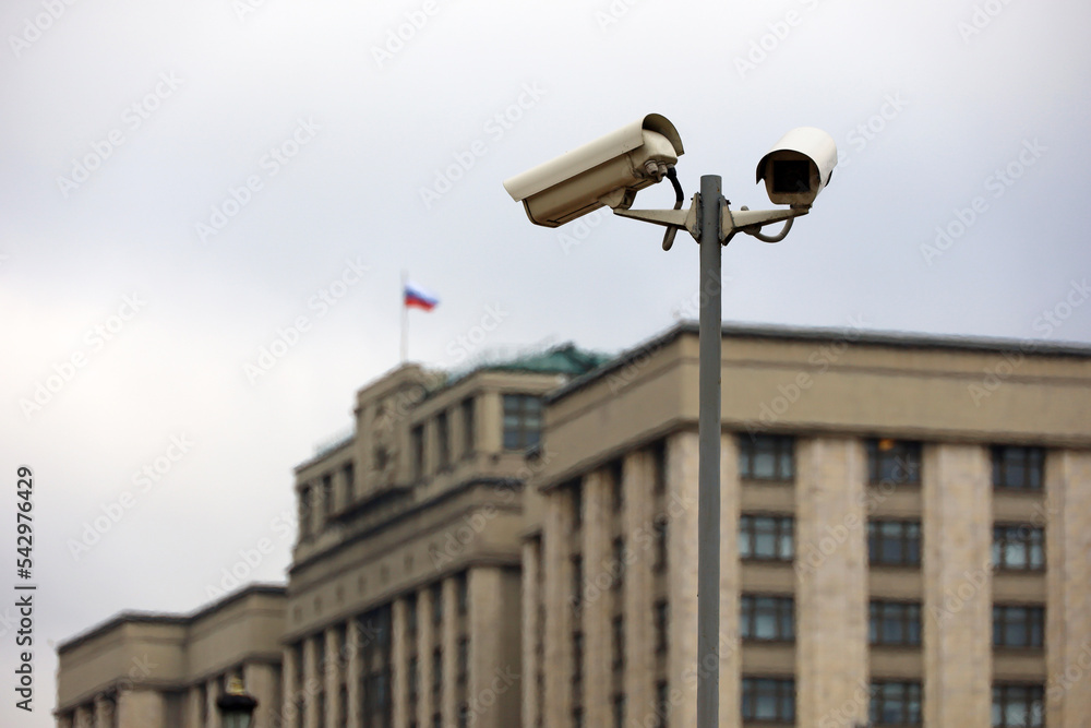 Security cameras against the parliament building of Russia with russian flag. Video surveillance and privacy issues concept