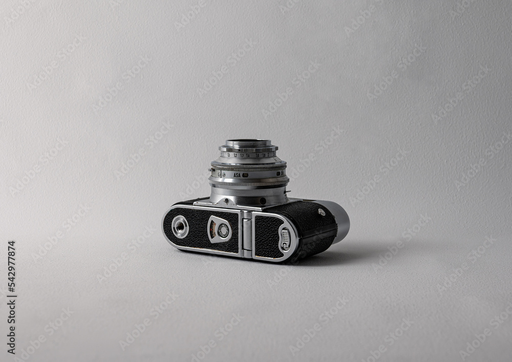 old photo camera lying on white background