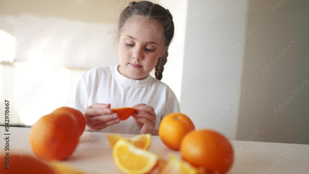 girl child eating oranges. happy family fruit healthy food kid concept. little girl dream daughter eating oranges at the table in the kitchen indoors. juicy fruits oranges are for a healthy diet girl child eating oranges. happy family fruit healthy food kid concept. little girl dream daughter eating oranges at the table in the kitchen indoors. juicy fruits oranges are for a healthy diet