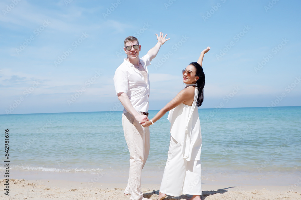 young couple walking on the beach with a happy smile, couple concept. young couple walking on the beach with a happy smile, couple concept.