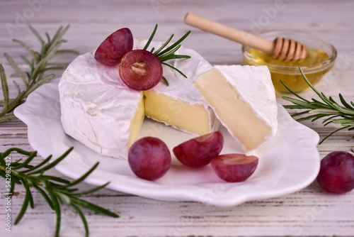 Camembert cheese in a cut on a wooden board.Close-up. 