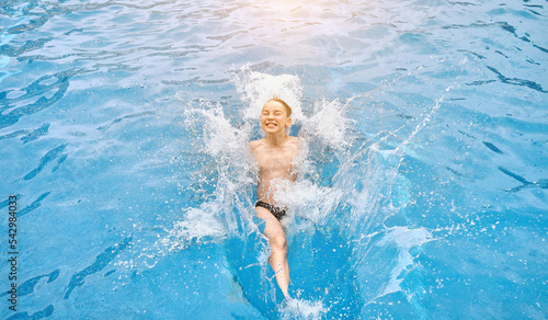 Child jump, swim in the pool, sunbathes, swimming in hot summer day. Relax, Travel, Holidays, Freedom concept. 