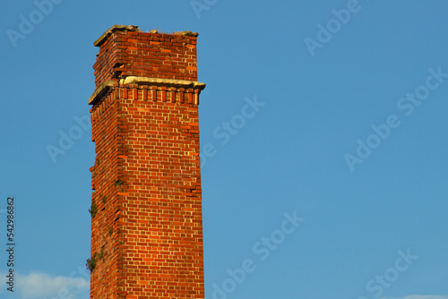 Konstfotografi old brick chimney isolated in the sky