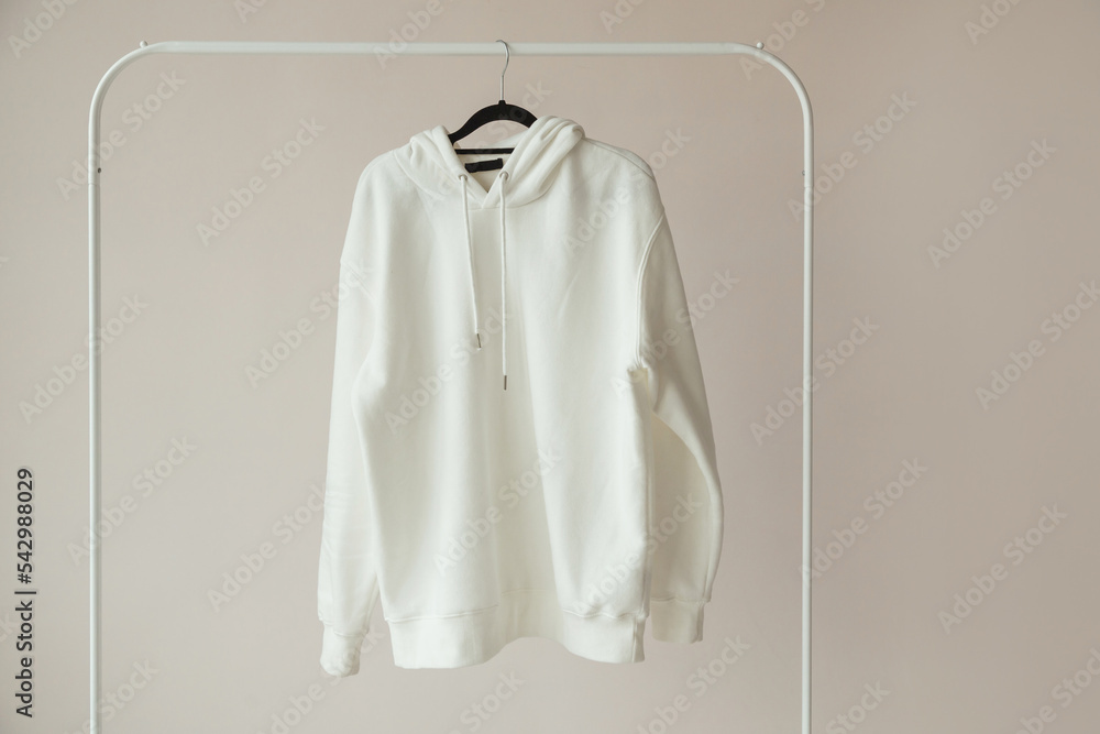 Blank White Hoodie, Sweatshirt Mock-up hanging on white Rack Hanger, front view