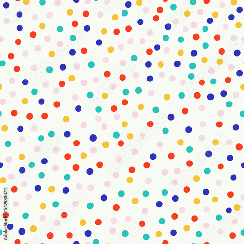 Abstract seamless pattern with hand drawn small dots. Vector polka dot texture. Cute and simple background with multicolored chaotic dots