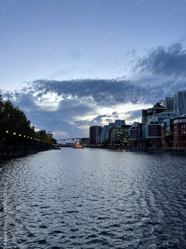 Naklejka premium Modern buildings by the waterfront at twilight. Taken in Salford Quays England. 
