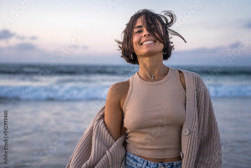 Laughing woman smiling toothy while enjoying of the windy summer evening