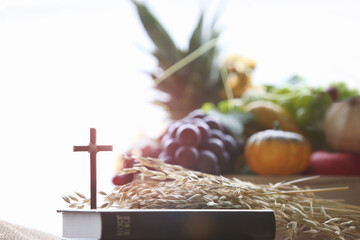 Church Thanksgiving Day bountiful fruit decoration and background with bible and jesus cross
