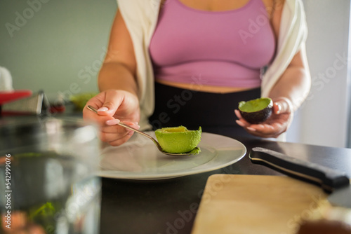 Close up view of the beautiful full figured woman feeling concentrated while preparing food