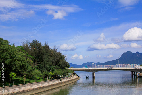 A beautiful scene of a seascape and cityscape with mountains under the clear blue sky