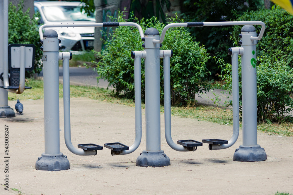 Public park grey workout machines or equipment to stay active and train muscle Public park grey workout machines or equipment to stay active and train muscle