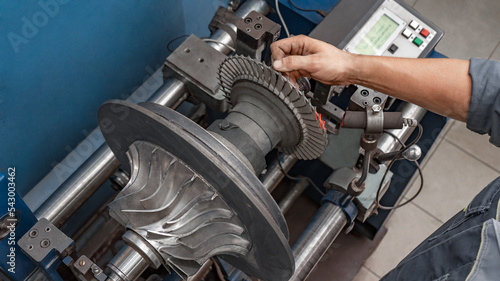 Turbine rotor balancing machine. Turbocharger repair and maintenance.