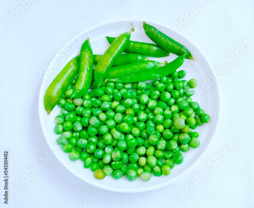 Green Peas legume raw pea fresh matar vegetable food Pisum sativum seed-pod P. sativum edible grains seeds  Erwt-petit Pois Erbse Pisello closeup view image stock photo photo