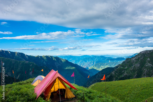 July 14th 2022, Himachal Pradesh India. Tents and camps with beautiful landscapes, valley and mountains in the background. Shrikhand Mahadev Kailash Yatra in the Himalayas. photo