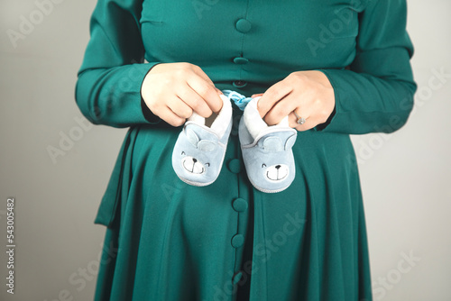 pregnant woman hand shoes