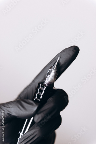 Permanent makeup device and beauty masters hands do permanent eyebrow makeup. 