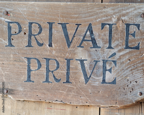 A sign stating private in English and French. photo