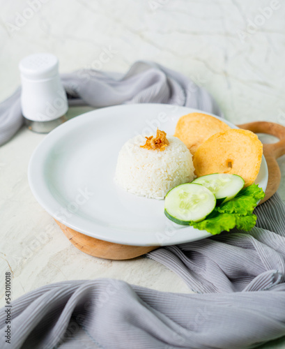 Cooked white rice on plate and white background photo