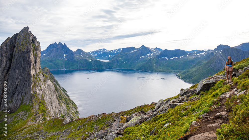 backpacker girl hiking on hesten overlooking Norway’s famous segla