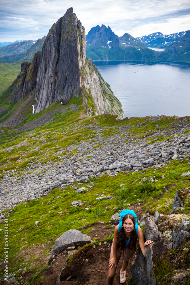 backpacker girl hiking on hesten overlooking Norway’s famous segla