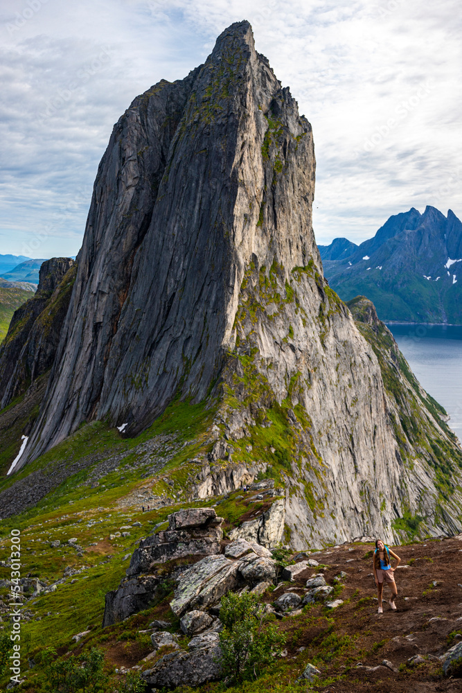 backpacker girl hiking on hesten overlooking Norway’s famous segla