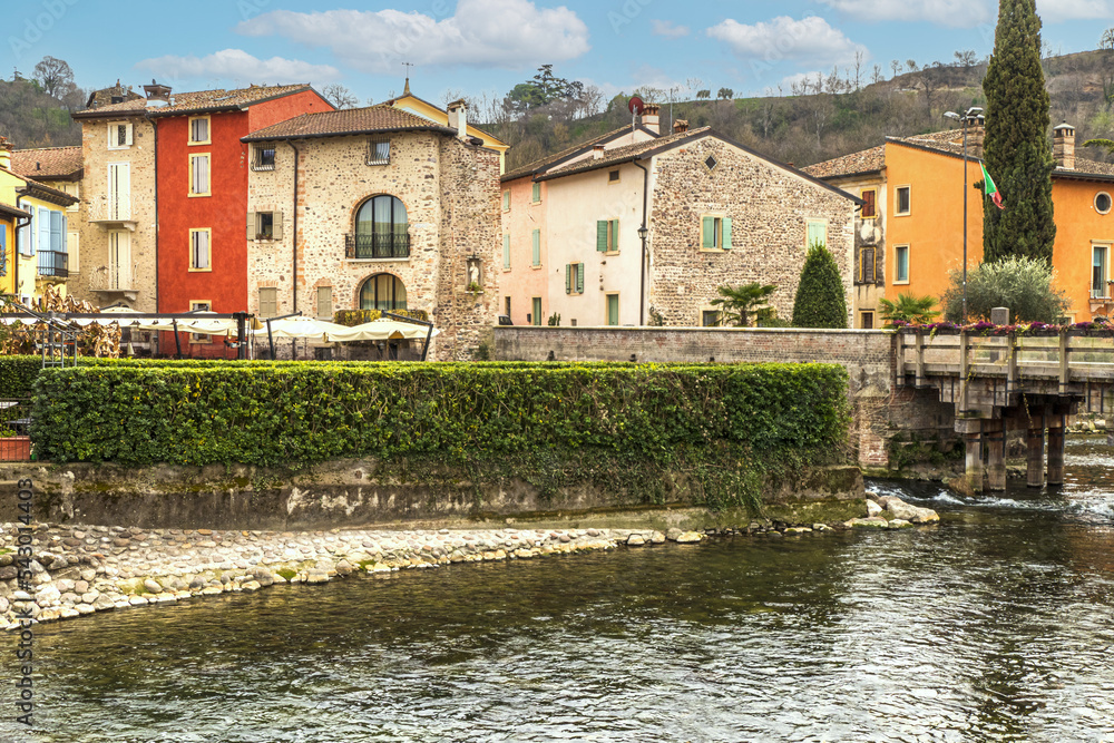 Fototapeta premium The beautiful colored houses of the hamlet of Borghetto sul Mincio reflecting on the water