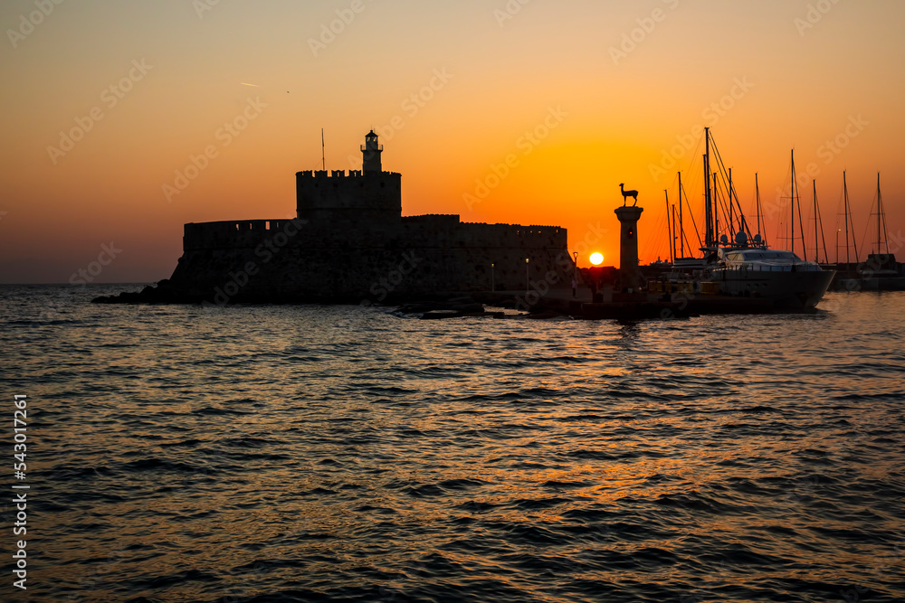 Agios Nikolaos fortress on the Mandraki harbour of Rhodes Greece at dusk