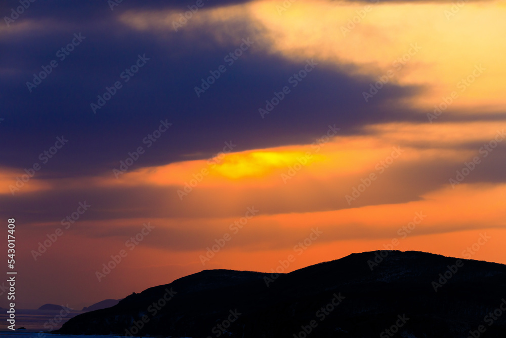 Beautiful seascape. The sun has set behind the hills. picturesque clouds at sunset.