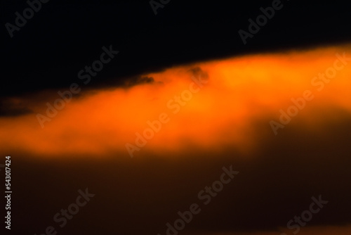 The sun has set behind the hills. Scenic clouds at sunset. Cloudy storm clouds.