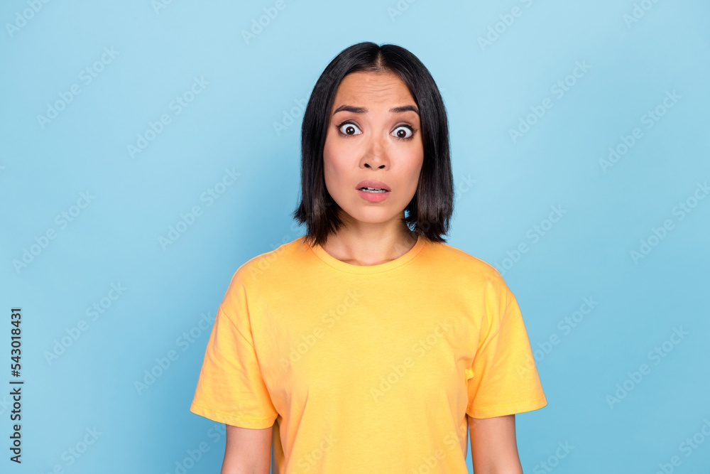 Photo of gorgeous unbelievable lovely girl with bob hairdo wear yellow t-shirt impressed staring isolated on blue color background Photo of gorgeous unbelievable lovely girl with bob hairdo wear yellow t-shirt impressed staring isolated on blue color background