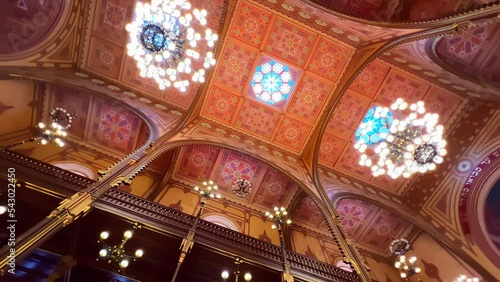 Richly decorated ceiling and vintage chandeliers in Dohany Street Synagogue, rotation, Budapest, Hungary