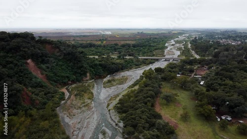 Dron shot above the river in front of the bridge in northern Argentina