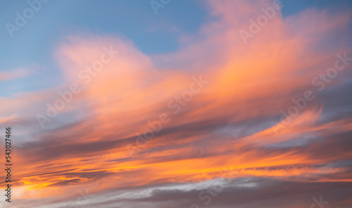 Beautiful bright orange sunset sky with clouds. Sunset sky background.