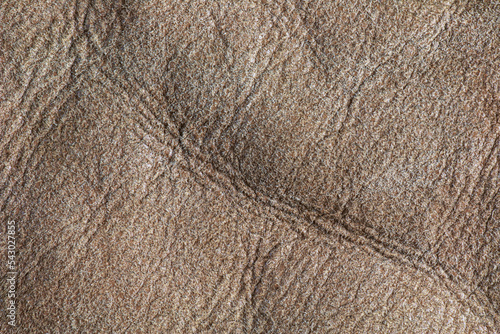 Background image of soft suede beige carpet. Dressing sheep wool closeup texture background. Top view.