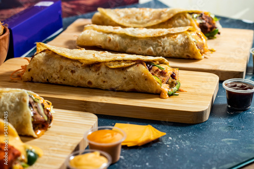 Beef Seekh Kabab Wrap, Chicken Afghani Kabab Wrap, Melt Cheese Paneer Wrap, Egg Cheesy Chicken Burger Wrap, Melt Cheese Chicken Wrap, Wedges and fries with salad dip and sauce isolated fastfood