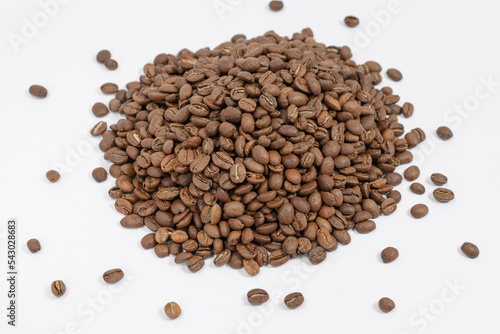 Fragrant and roasted coffee beans on a white background, place for inscription and advertising.