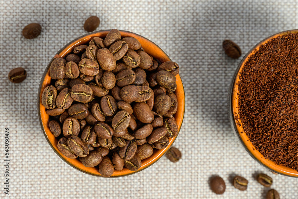 Fototapeta premium Ground and whole-grain coffee on a light background.
