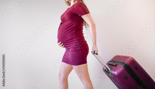 Pregnant woman with bag for maternity hospital - Pregnant woman ready to travel