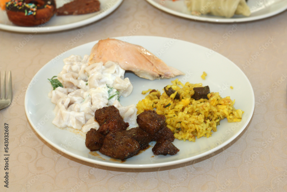 Close-up view of chicken liver, rice, chicken and russian salad with spices on it, a traditional homemade delicious liver dish. Close-up view of chicken liver, rice, chicken and russian salad with spices on it, a traditional homemade delicious liver dish.