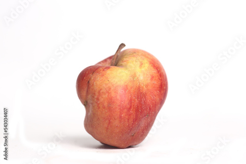 Concept of ugly food - red apple on white background