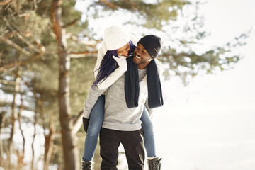African american couple in a winter forest