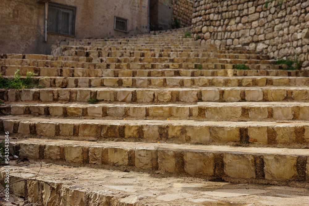 Fototapeta premium Old stone stairs leading to houses on the streets of Mardin