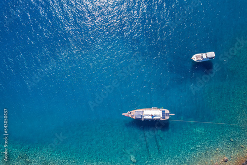 Aerial view beautiful white yacht on clear blue sea in Turkey. Concept cruise travel by drone © Parilov