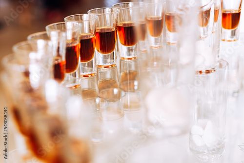 A close-up of wineglass with an alcoholic beverage on a transpar photo